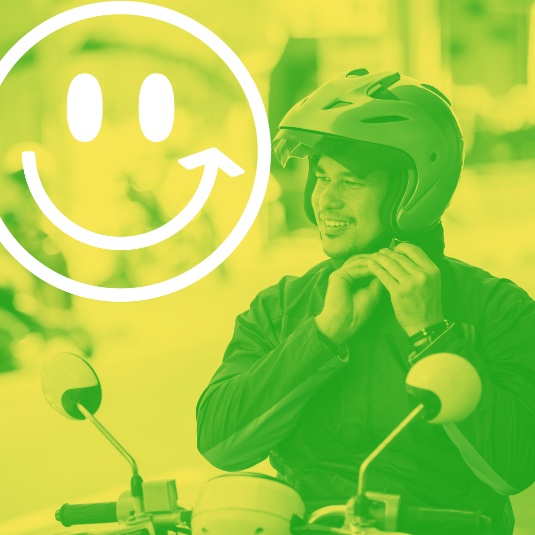 Person putting on a motorcycle helmet with the yellow Good Move smile logo overlaid